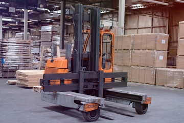 Timber Flooring Factory. Pile of cut wood in factory storage warehouse. Lumber in warehouse.