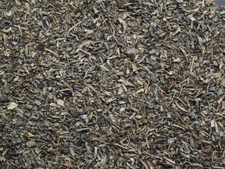 Organic dried green tea leaves. Background. top view.
