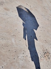 Shadow of a man with an umbrella
