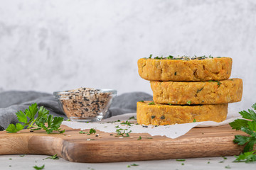 Raw veggie burger with chickpeas, vegetables and parsley leaves on kitchen countertop