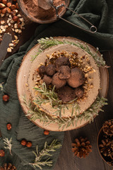 Delicious naked chocolate and hazelnuts cake on table rustic wood kitchen countertop. Top view. Flat lay