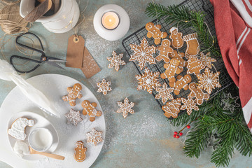 Bright Christmas or New Year wooden background with fir branches, Christmas decorations, Christmas gingerbread cookies, Christmas sweets.