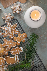 Bright Christmas or New Year wooden background with fir branches, Christmas decorations, Christmas gingerbread cookies, Christmas sweets.