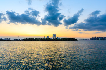Fototapeta premium Beautiful suzhou city skyline and architecture with lake at sunset,China.