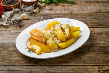 fried potatoes with onions on wooden table