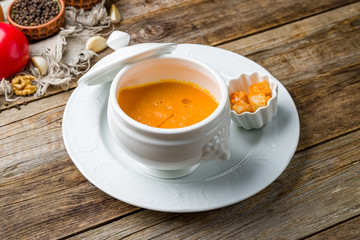Soup cream of pumpkin on wooden table