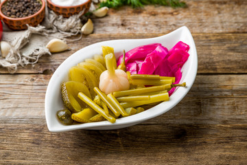 plate of pickles on wooden table