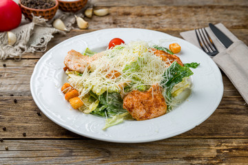 Salad caesar with chicken on white plate