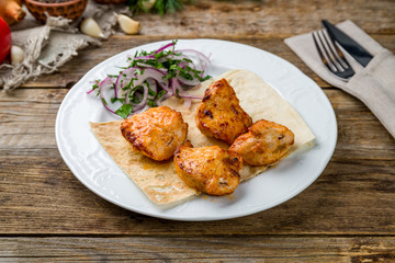 chicken kebab on white plate