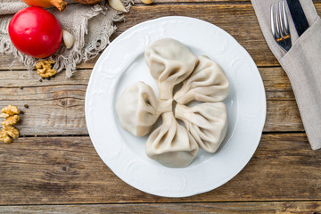 Khinkali with lamb on wooden table