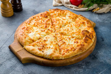 khachapuri with cheese on wooden table