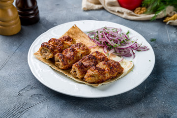 Lamb Lula kebab on wooden table