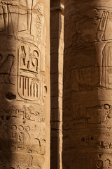 Karnak Temple, complex of Amun-Re. Embossed hieroglyphics on columns. Great Hypostyle Hall. Min  is an ancient Egyptian god. Luxor Governorate, Egypt.