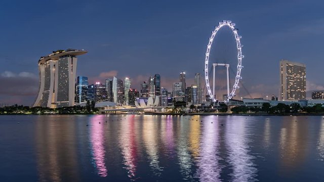 TL/ZI Asia, Singapore,  night to day transition, zoom in time lapse of the financial district and Singapore skyline at dawn, showing Marina Bay Sands and Singapore flyer in foreground.