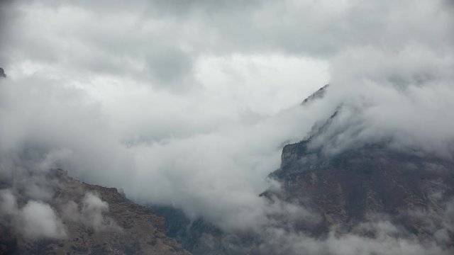 Clouds rolling over canyon in the Wasatch Mountains in Utah Valley.