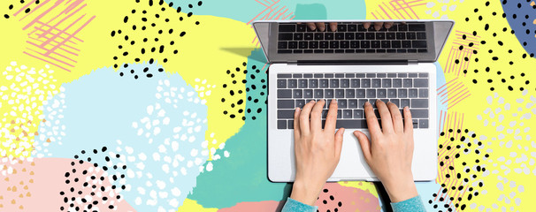 Person using a laptop computer on memphis background