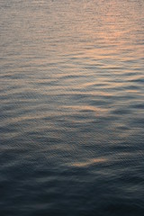 yellow sunset reflected on the dark water