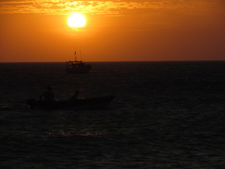 Fishing boat starting work at sunset.