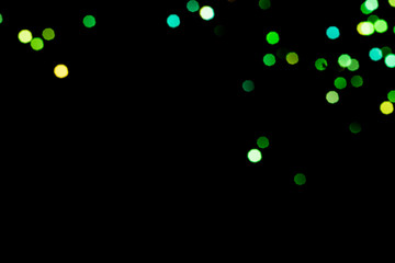 Fototapeta na wymiar big green and golden bokeh for background on black. Christmas lights. overlay layer