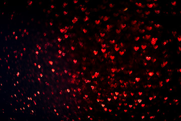 Fototapeta na wymiar Valentine's day red background on black. Hearts shape bokeh. Overlay layer.