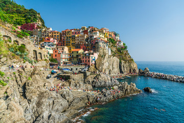 Fototapeta na wymiar View at Manarola village in Cinque Terre, Italy, with its traditional colorful houses and Ligurian Sea coast