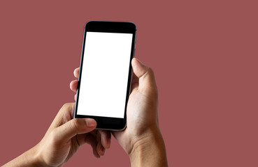 Fototapeta na wymiar Hand holding white mobile phone with blank white screen baked clay background.