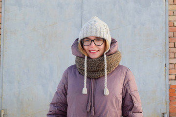 Smiling blonde blue eyes teenager in winter clothing 