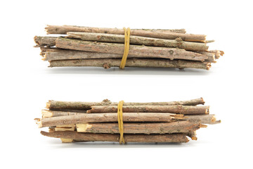 2 bundles of small wooden bars closeup isolated on white background
