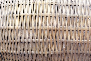 Old pale yellow pattern bamboo craft background, native weaving bamboo equipment in Thailand.
