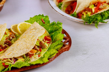 Delicious soft tortillas with salad and meat. Mexican cuisine.