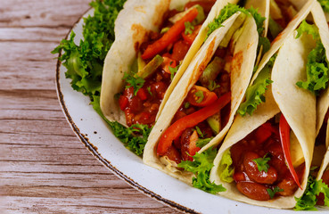 Soft tortillas with chili beans, beef and vegetable. Mexican food.