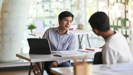 Architect team while they are talking together in the office.