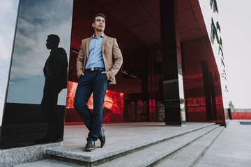 Confident man at entrance to office bulding stock photo