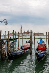 Fototapeta na wymiar Jetty with gondolas on the Venice promenade