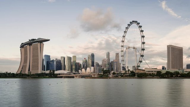TL/ZI Asia, Singapore, zoom in time lapse of the financial district and Singapore skyline at dawn, showing Marina Bay Sands and Singapore flyer in foreground.