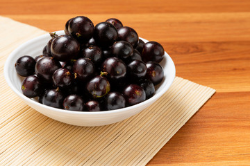 Jabuticaba in the bowl - close up. Jaboticaba or Jabuticaba is the native Brazilian grape tree. Species Plinia Cauliflora. Brazilian Berry.