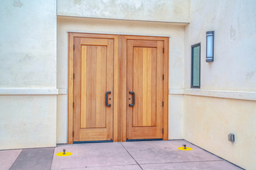 Closed double wooden entrance doors on cloudy day