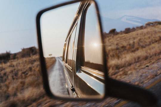 Look Back Into The Side Mirror Of A Van Car