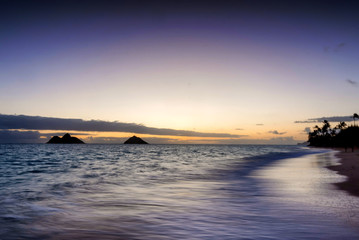Sunrise scene at Lanikai Beach in Kailua, Hawaii.  Lanikai is regularly ranked among the top...