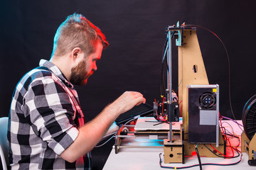 Fototapeta na wymiar Male architect using 3D printer in office