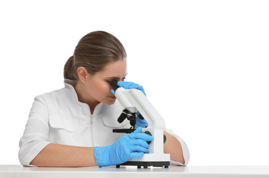 Scientist using modern microscope at table isolated on white. Medical research
