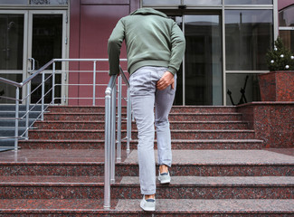 Man suffering from hemorrhoid pain outdoors, back view