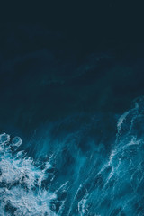 Aerial view to sea landscape, water with waves and rocks. Dramatic colors photo. Image with place for text.