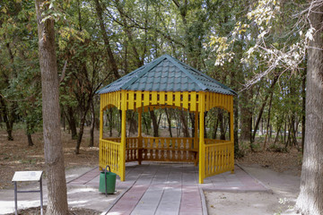 Covered gazebo in the park among the trees