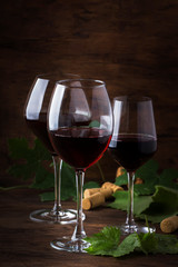 Wine glass. Selection of red wines on wine tasting. Dry, semi-dry, sweet red wine on old wooden table background. Copy space
