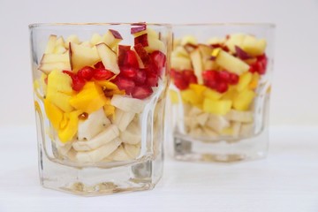Mango & vanilla ice cream served with Mixed chopped fruits like Bananas, Mangoes, pomegranates, apples garnished with chocolate syrup in a glass. known as Gad bad ice cream in India © Manaswi