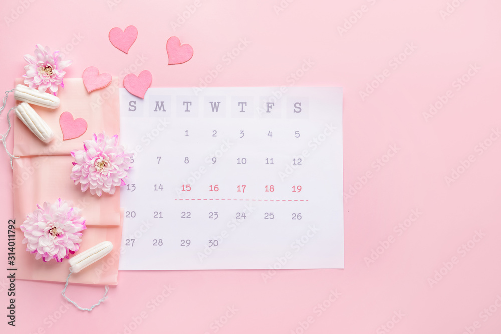 Wall mural Menstrual calendar with feminine products on color background