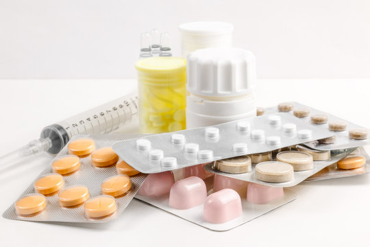 Medications of various types and forms of the factor for multifunctional use and an injection tool on a white background