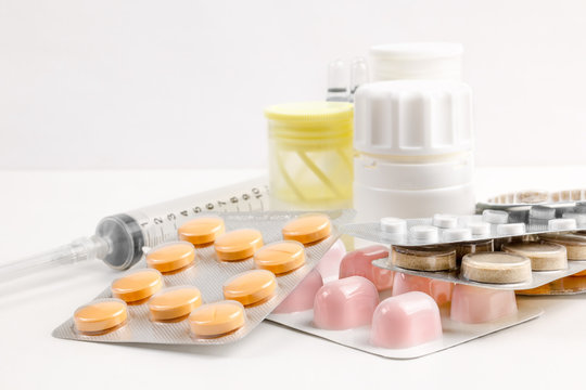 Medications of various types and forms of the factor for multifunctional use and an injection tool on a white background
