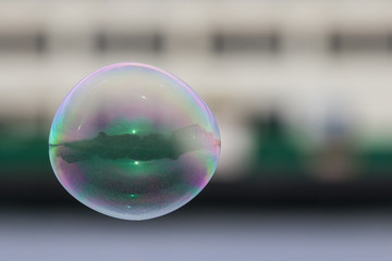 A Large Bubble Reflects Waterfront Buildings